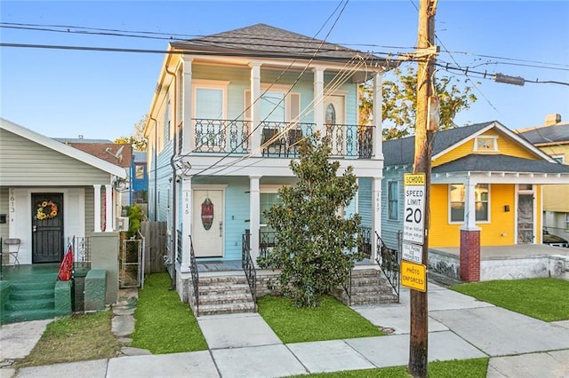 view of front of house with a porch and a balcony