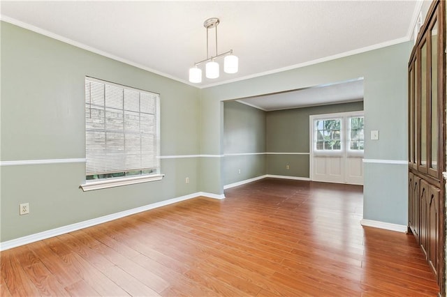 unfurnished room featuring crown molding and wood-type flooring