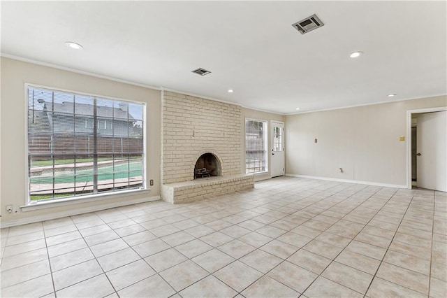 unfurnished living room featuring a fireplace, light tile patterned floors, and a wealth of natural light