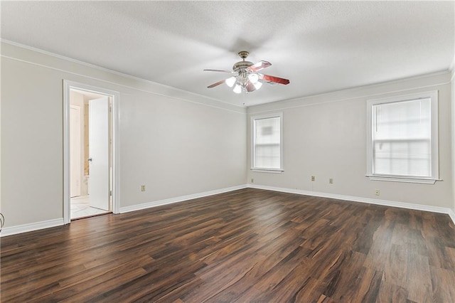 unfurnished room featuring dark wood-type flooring, ornamental molding, and ceiling fan