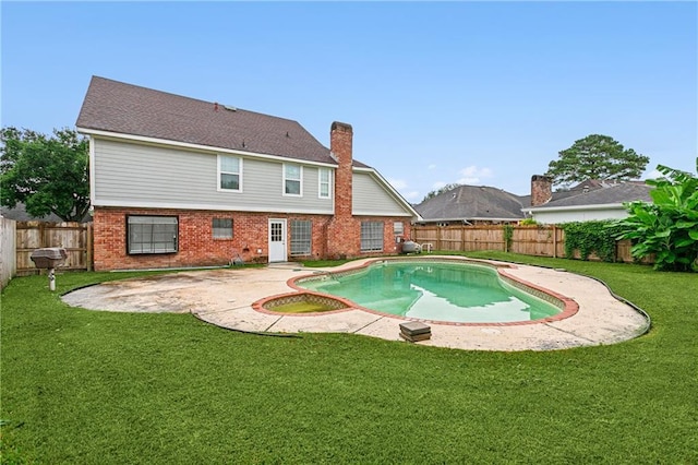 view of swimming pool featuring a yard and a patio area