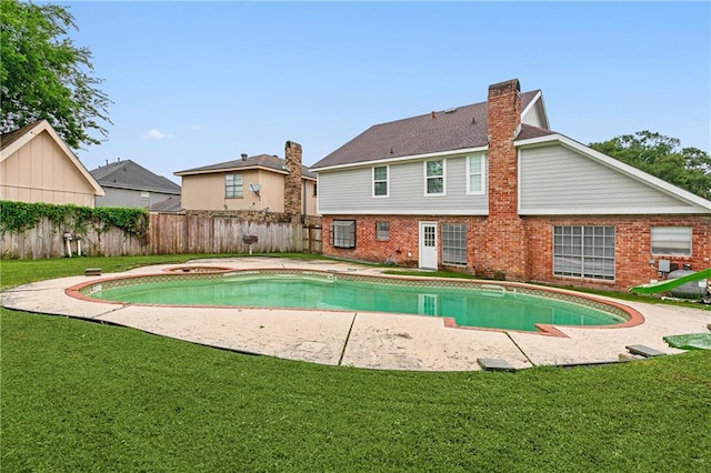 view of pool with a yard