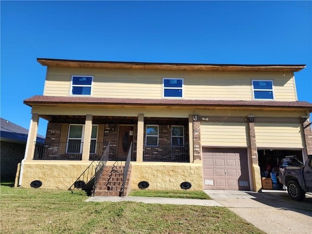 view of front of house featuring covered porch, a garage, and a front yard