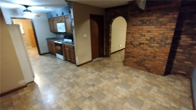 kitchen featuring ceiling fan and white appliances