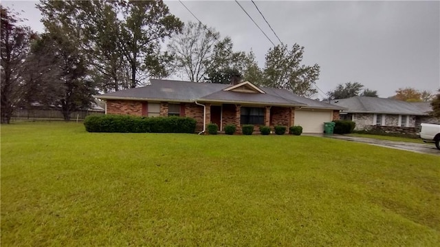 ranch-style home featuring a garage and a front lawn