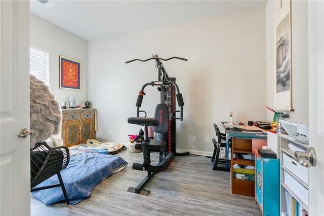 workout room with wood-type flooring