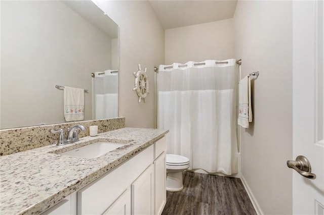 bathroom with hardwood / wood-style floors, vanity, toilet, and a shower with curtain