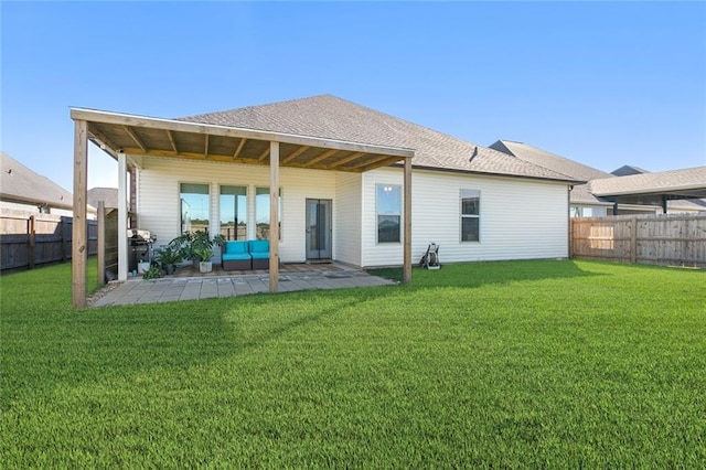 back of property featuring a patio area and a yard