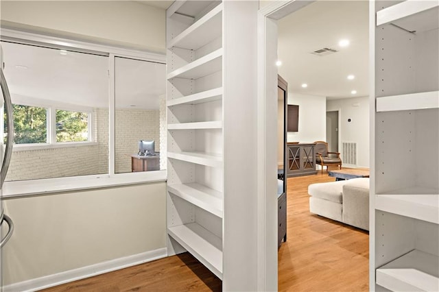 spacious closet featuring hardwood / wood-style floors