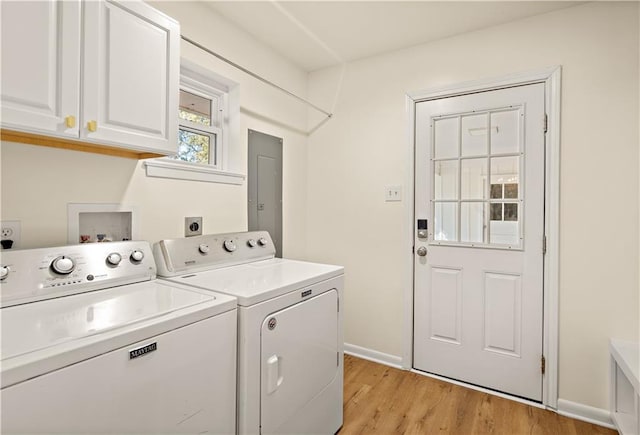 laundry area with independent washer and dryer, cabinets, and light wood-type flooring