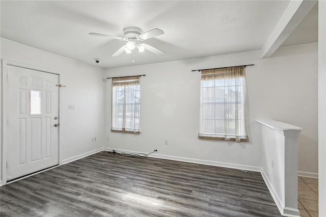 foyer with beamed ceiling, plenty of natural light, ceiling fan, and dark wood-type flooring