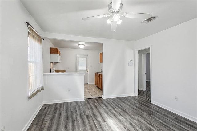 unfurnished living room with ceiling fan and light hardwood / wood-style flooring