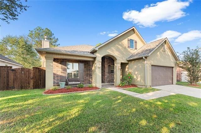 view of front of home with a front yard and a garage