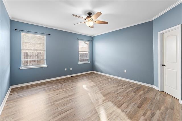 empty room with wood-type flooring, ceiling fan, and crown molding