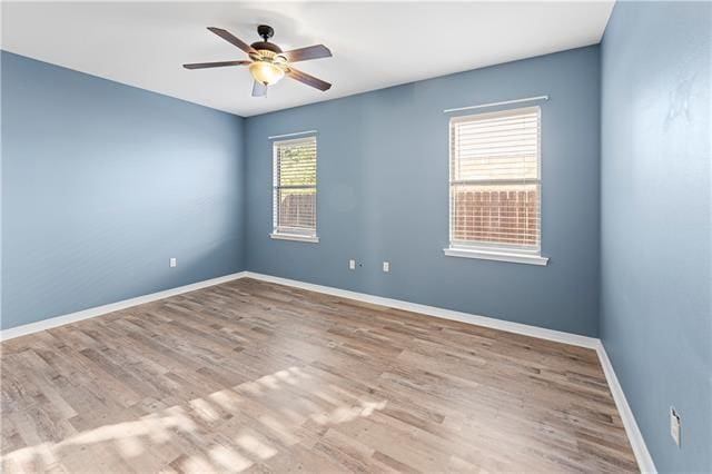 unfurnished room featuring light wood-type flooring and ceiling fan