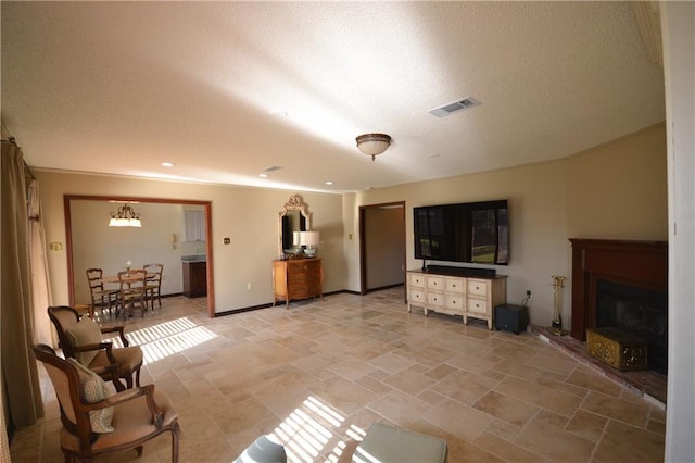 living room featuring a chandelier and a textured ceiling