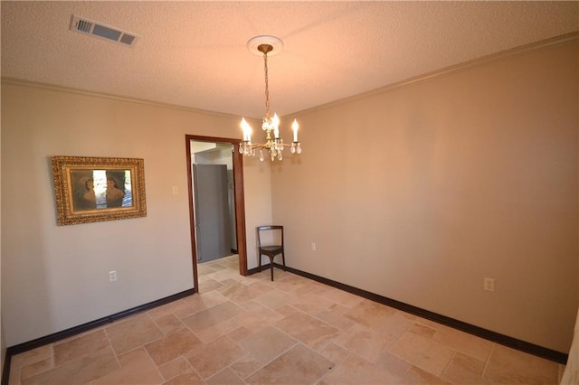 empty room with a chandelier and a textured ceiling