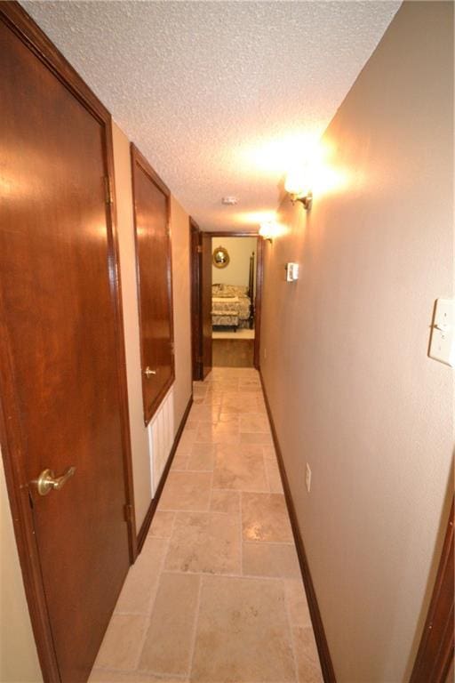 hallway featuring a textured ceiling