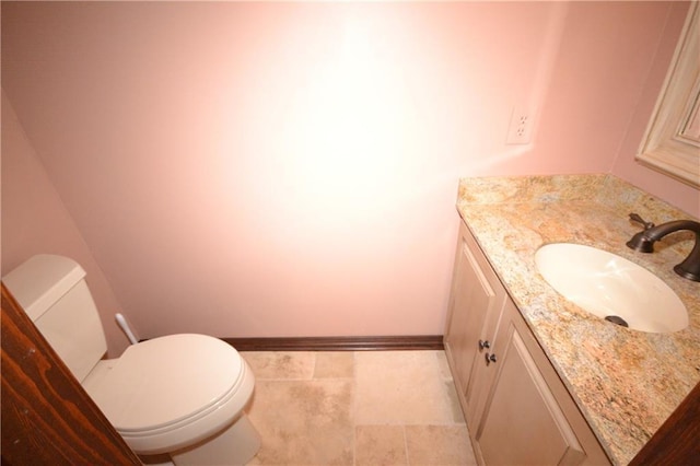 bathroom with tile patterned floors, vanity, and toilet