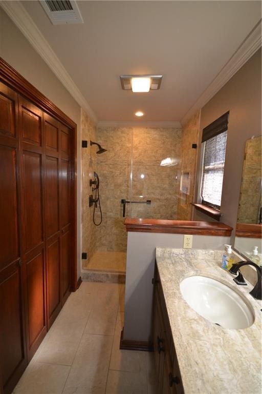 bathroom with tile patterned flooring, vanity, an enclosed shower, and crown molding