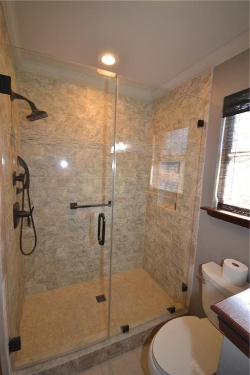 bathroom with vanity, crown molding, tile patterned flooring, toilet, and an enclosed shower