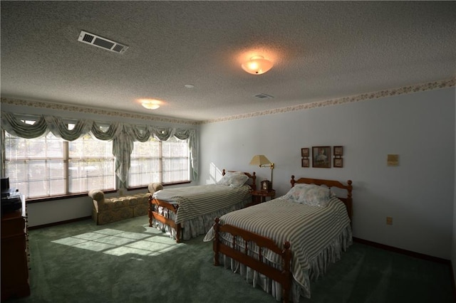 bedroom featuring carpet flooring and a textured ceiling