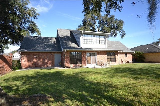 rear view of property with a yard