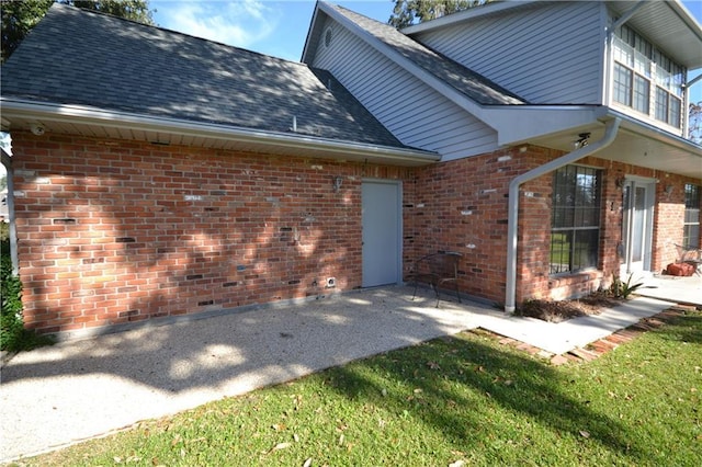 back of house featuring a yard and a patio