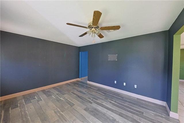 spare room with ceiling fan and dark hardwood / wood-style flooring