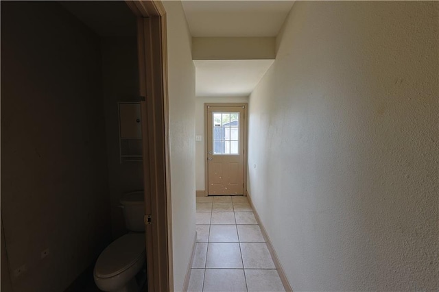 hall featuring light tile patterned floors