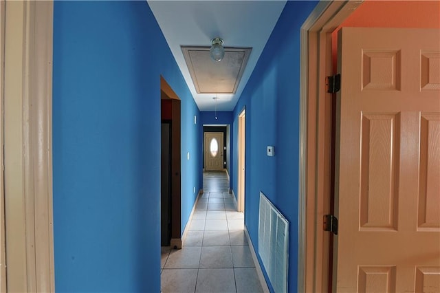 corridor featuring light tile patterned floors