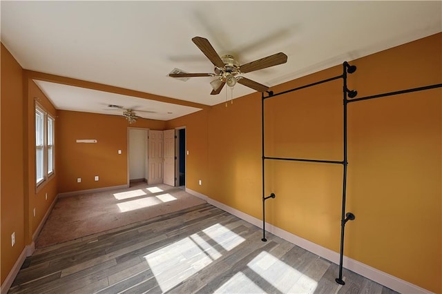 empty room with hardwood / wood-style flooring and ceiling fan