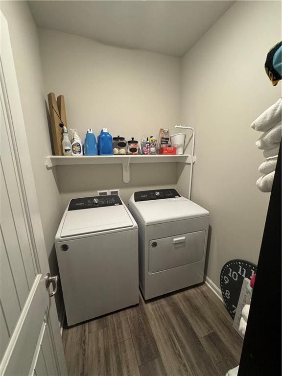 laundry area featuring separate washer and dryer, dark wood finished floors, and laundry area