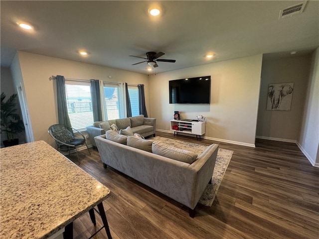 living room featuring dark wood finished floors, visible vents, recessed lighting, and baseboards