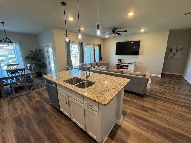 kitchen with a kitchen island with sink, a sink, white cabinets, dishwasher, and dark wood-style flooring