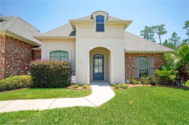 view of exterior entry with a yard