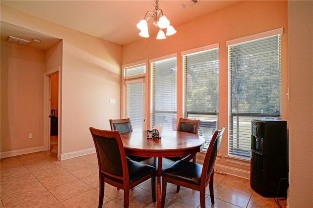 tiled dining area featuring an inviting chandelier