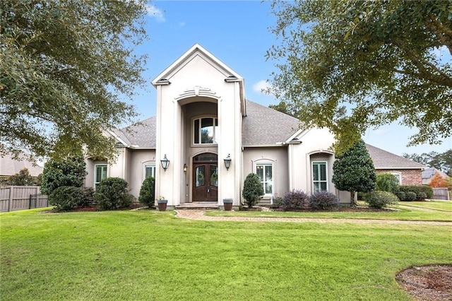 view of front of property featuring a front lawn and french doors