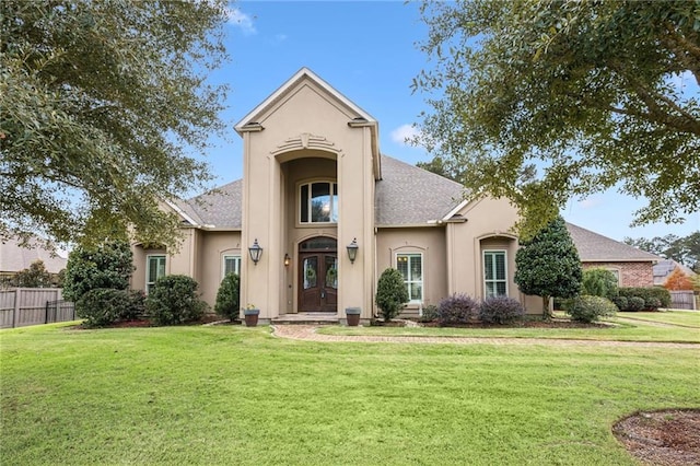 view of front of home featuring a front yard and french doors