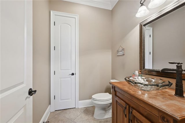 bathroom with vanity, crown molding, toilet, and tile patterned floors