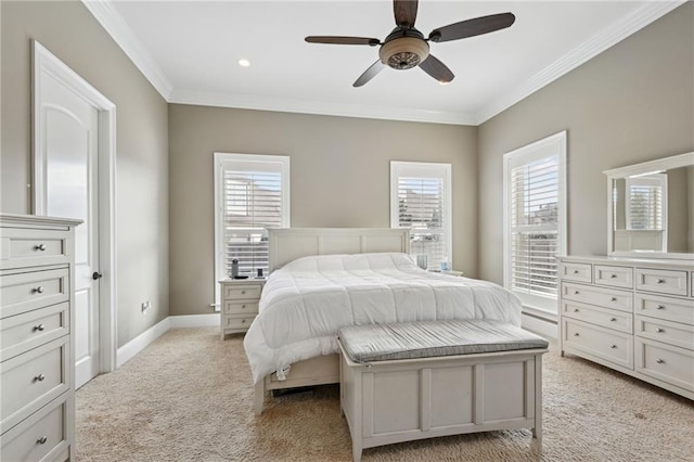 carpeted bedroom with ceiling fan and ornamental molding