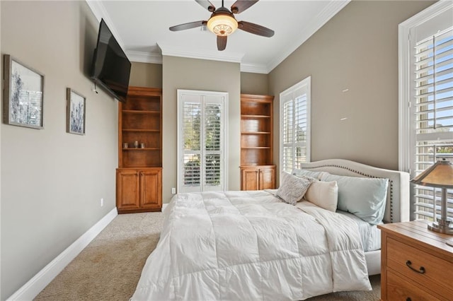 carpeted bedroom featuring crown molding and ceiling fan