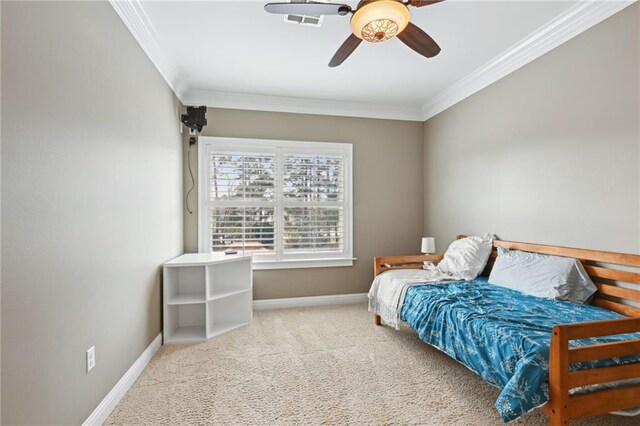 bedroom featuring ceiling fan, crown molding, and carpet floors