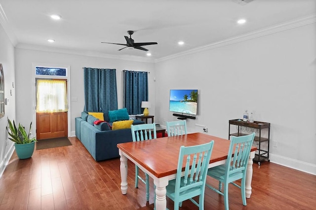 dining area with crown molding, hardwood / wood-style floors, and ceiling fan