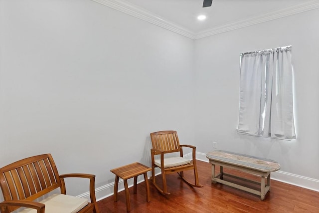 sitting room featuring hardwood / wood-style flooring and ornamental molding