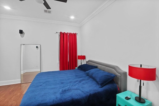 bedroom with ceiling fan, wood-type flooring, and ornamental molding