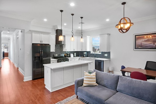 kitchen featuring pendant lighting, a center island, black appliances, white cabinets, and light hardwood / wood-style floors