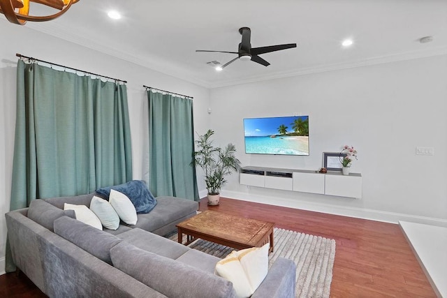 living room with hardwood / wood-style floors, ceiling fan, and ornamental molding