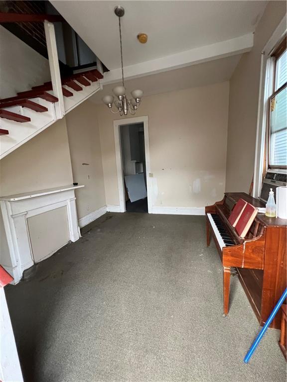 miscellaneous room with a notable chandelier