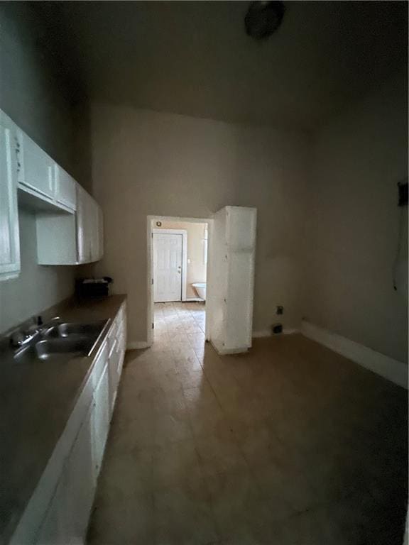 kitchen with white cabinetry and sink